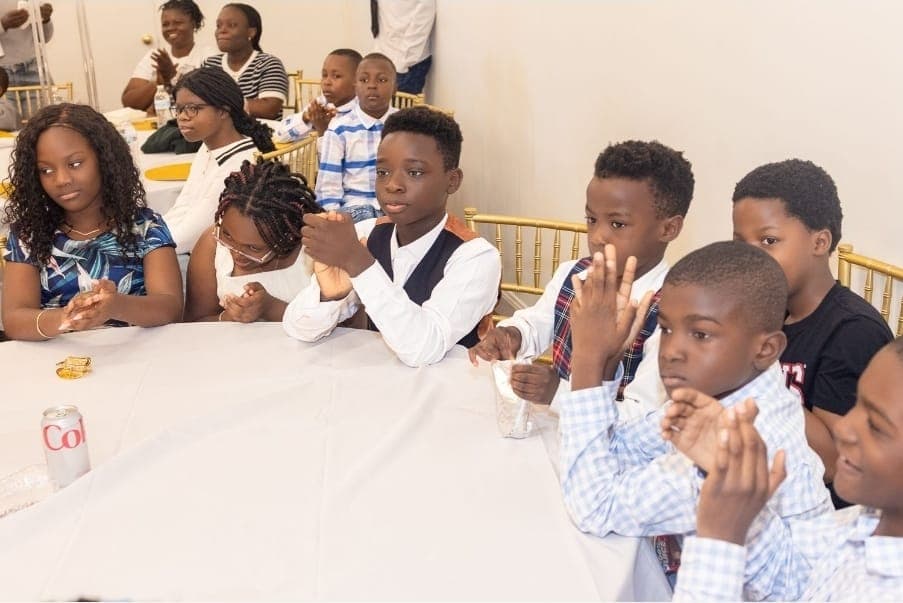 Children applaud from their table during the program.